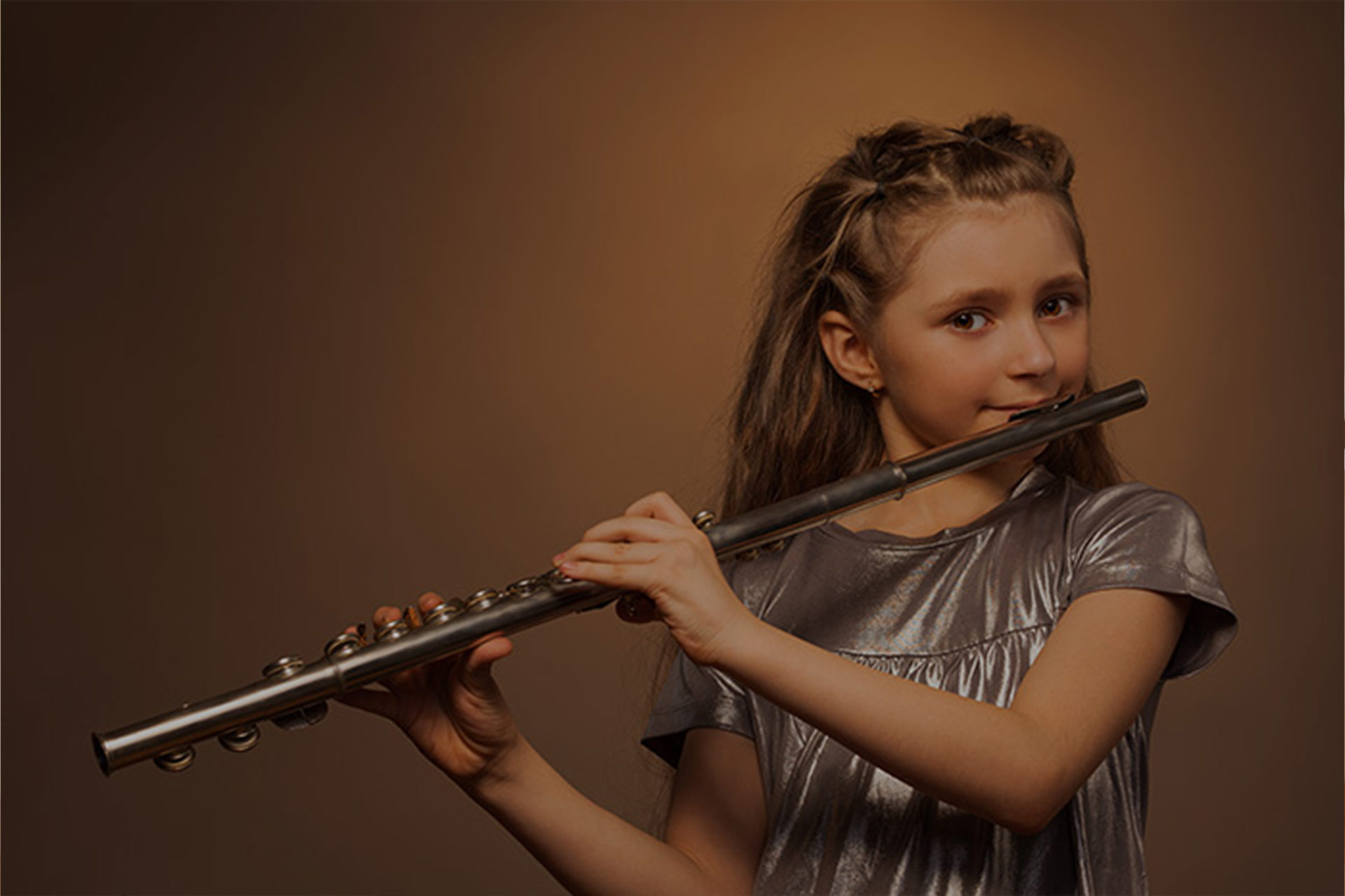 A young girl playing flute