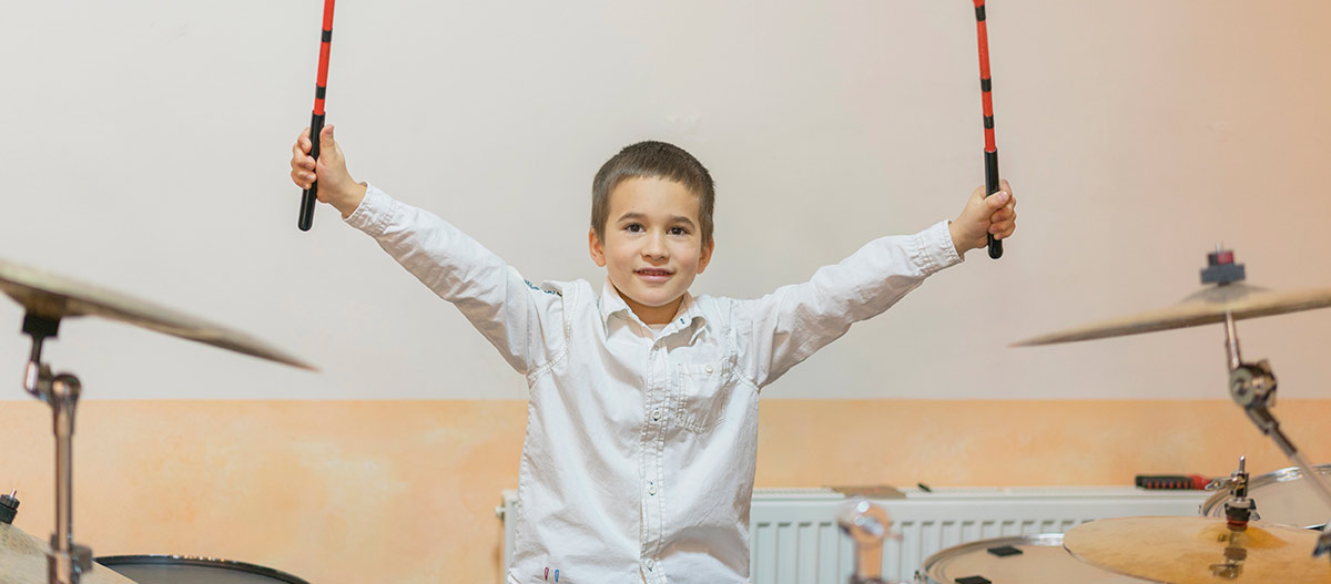 Boy holding the drum sticks up