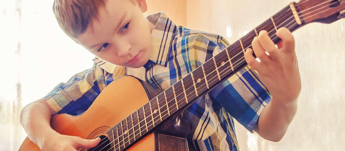 Young boy playing the guitar