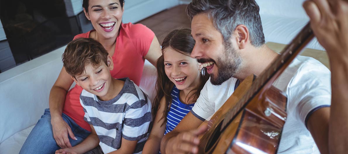 A happy family singing and jamming at home