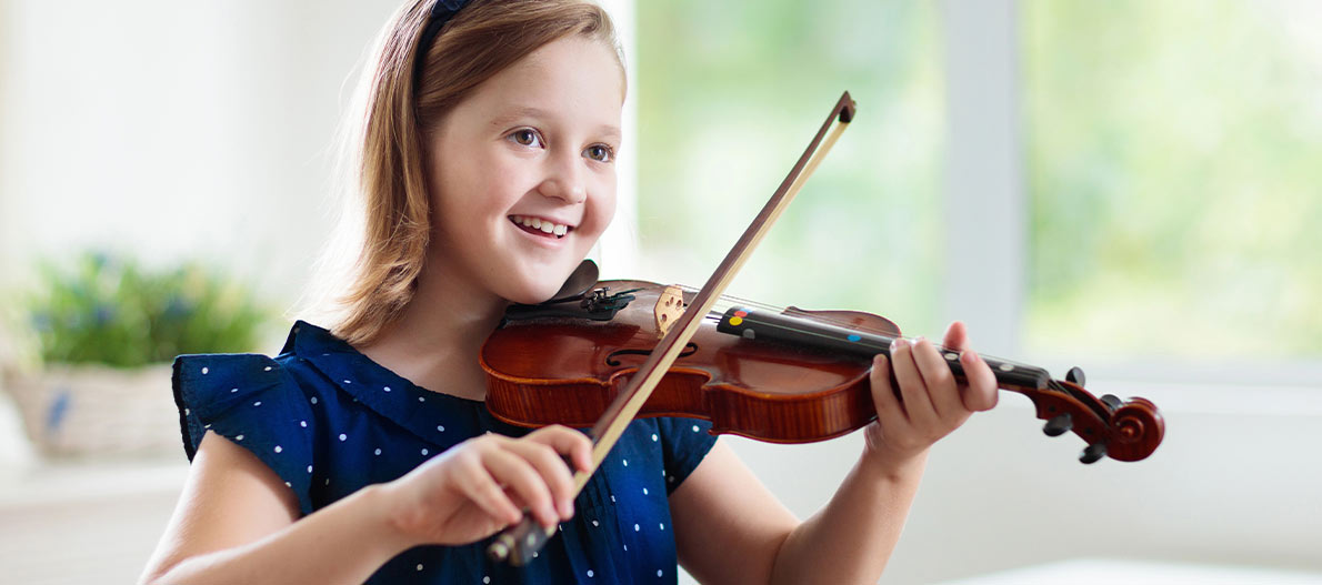 A happy girl playing the violin