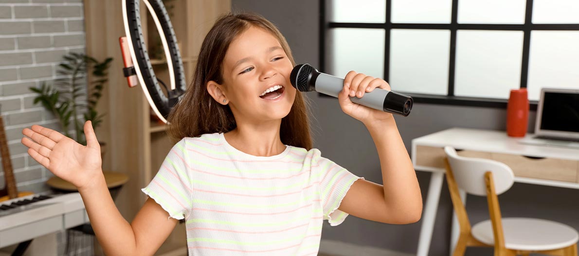 A happy girl singing at home