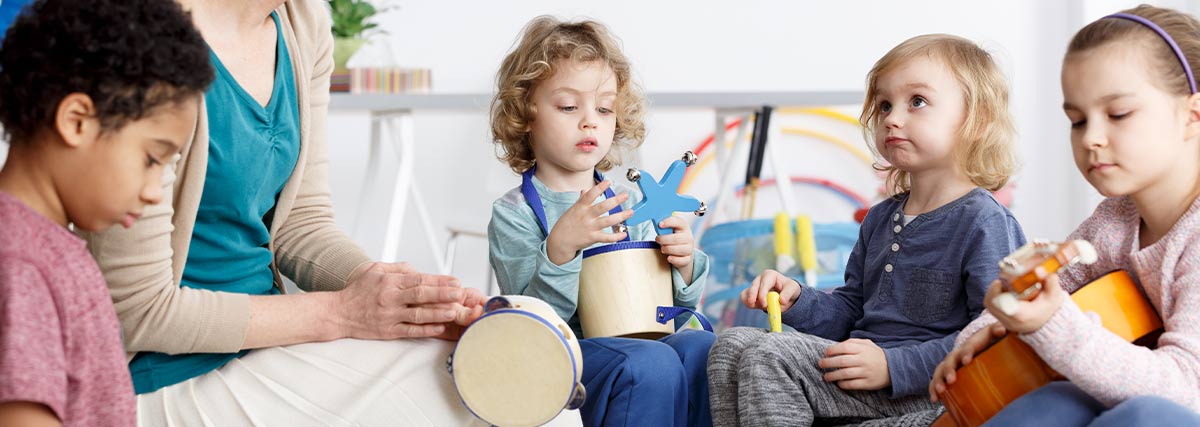 Children with teacher in music class