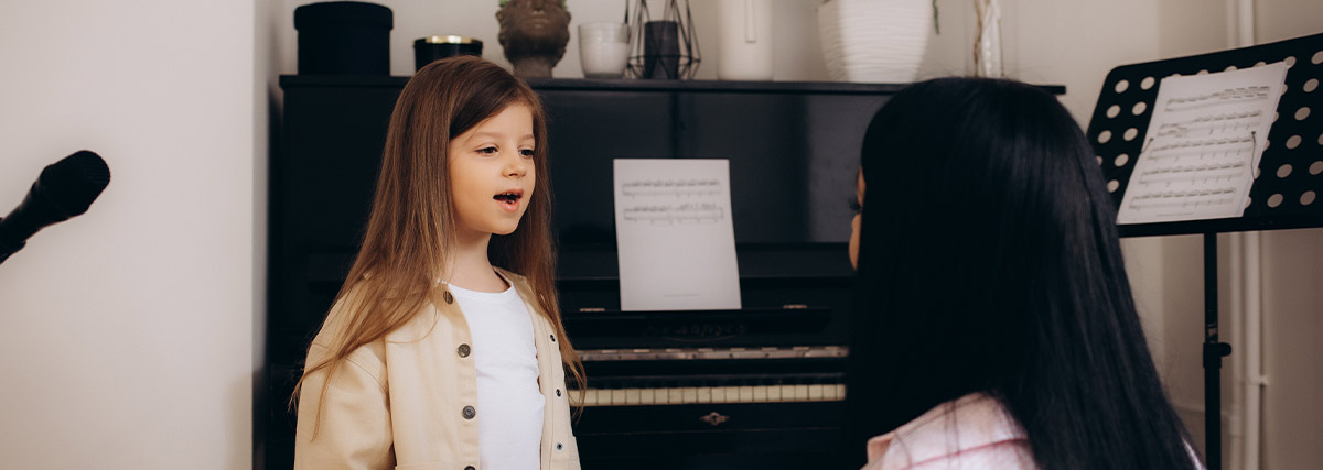 Child singing with teacher during a trial music lesson