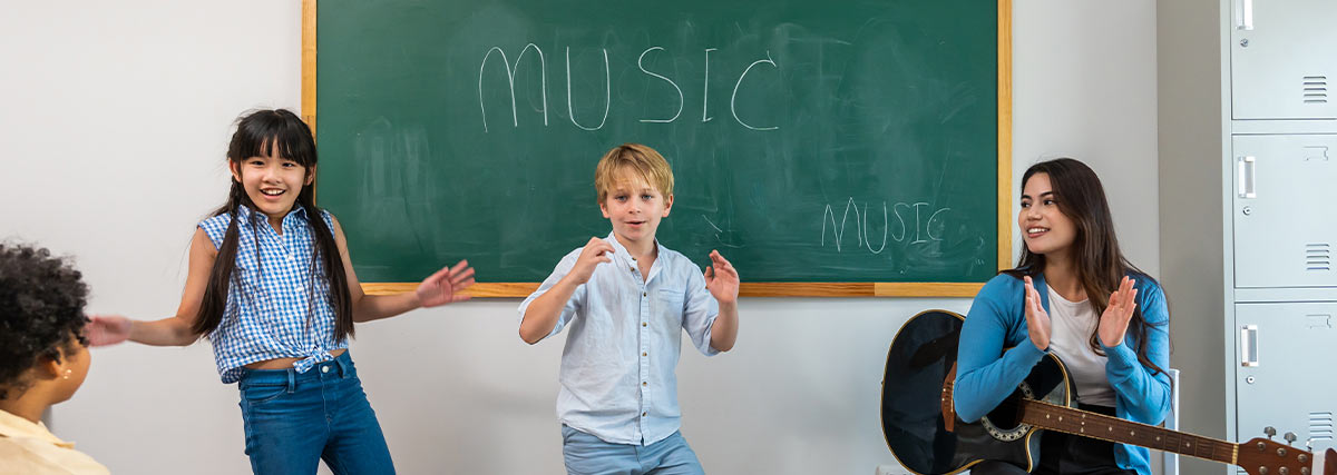 Children enjoying a group music lesson with a teacher