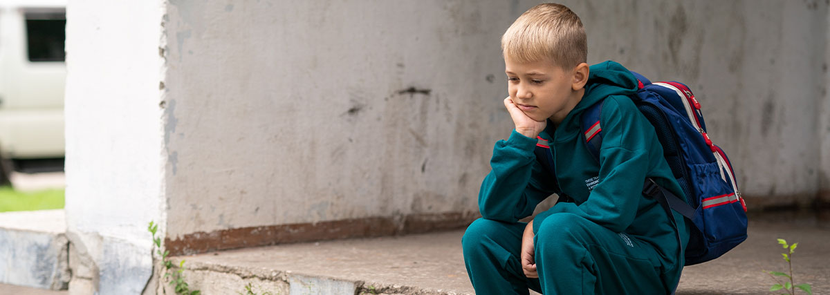 Young child feeling discouraged and sitting on stairs